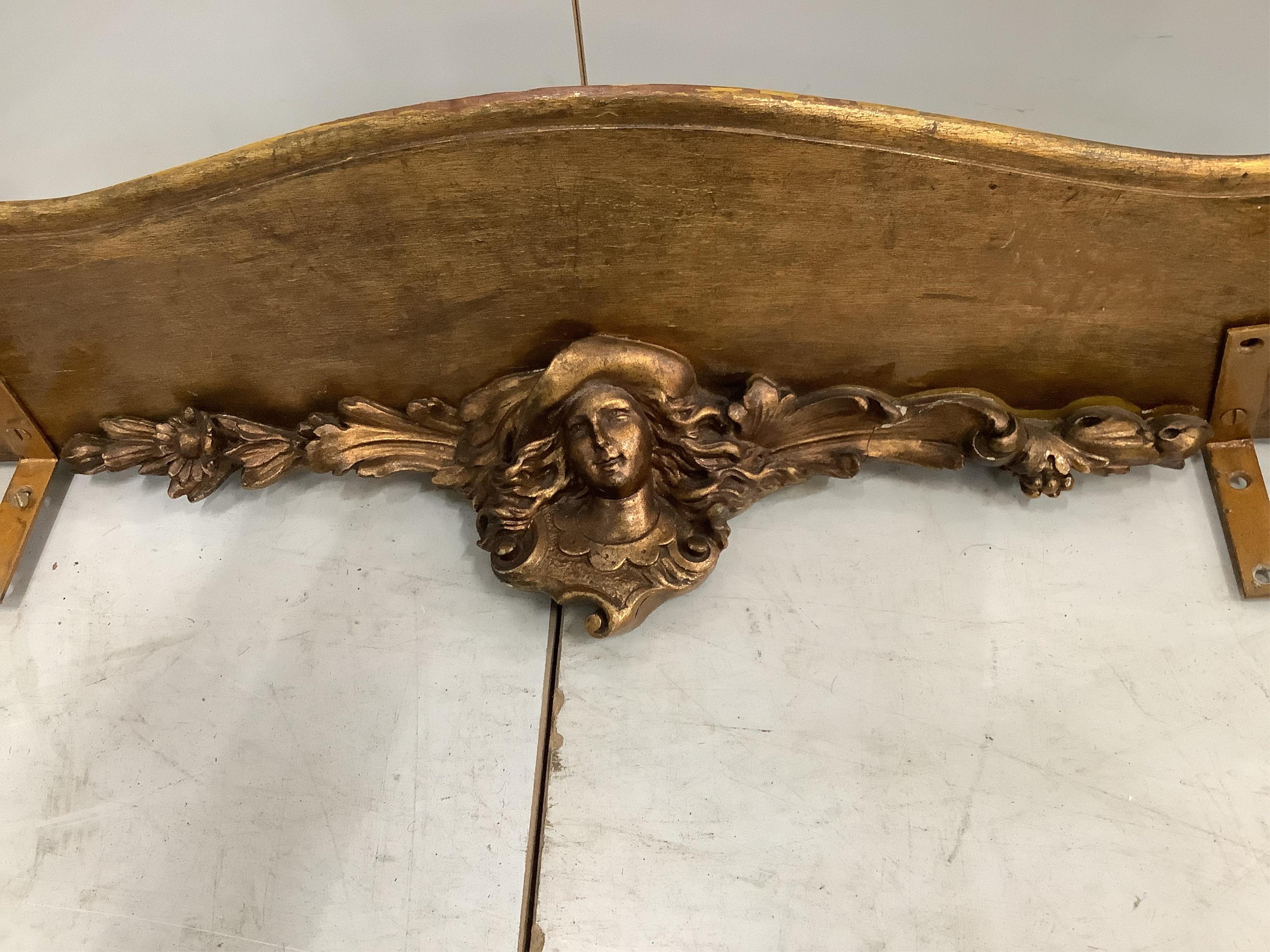 An 18th century style gilt composition cherub wall bracket, width 95cm. Condition - poor to fair